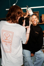 Two people with Jägermeister branding in a casual setting.