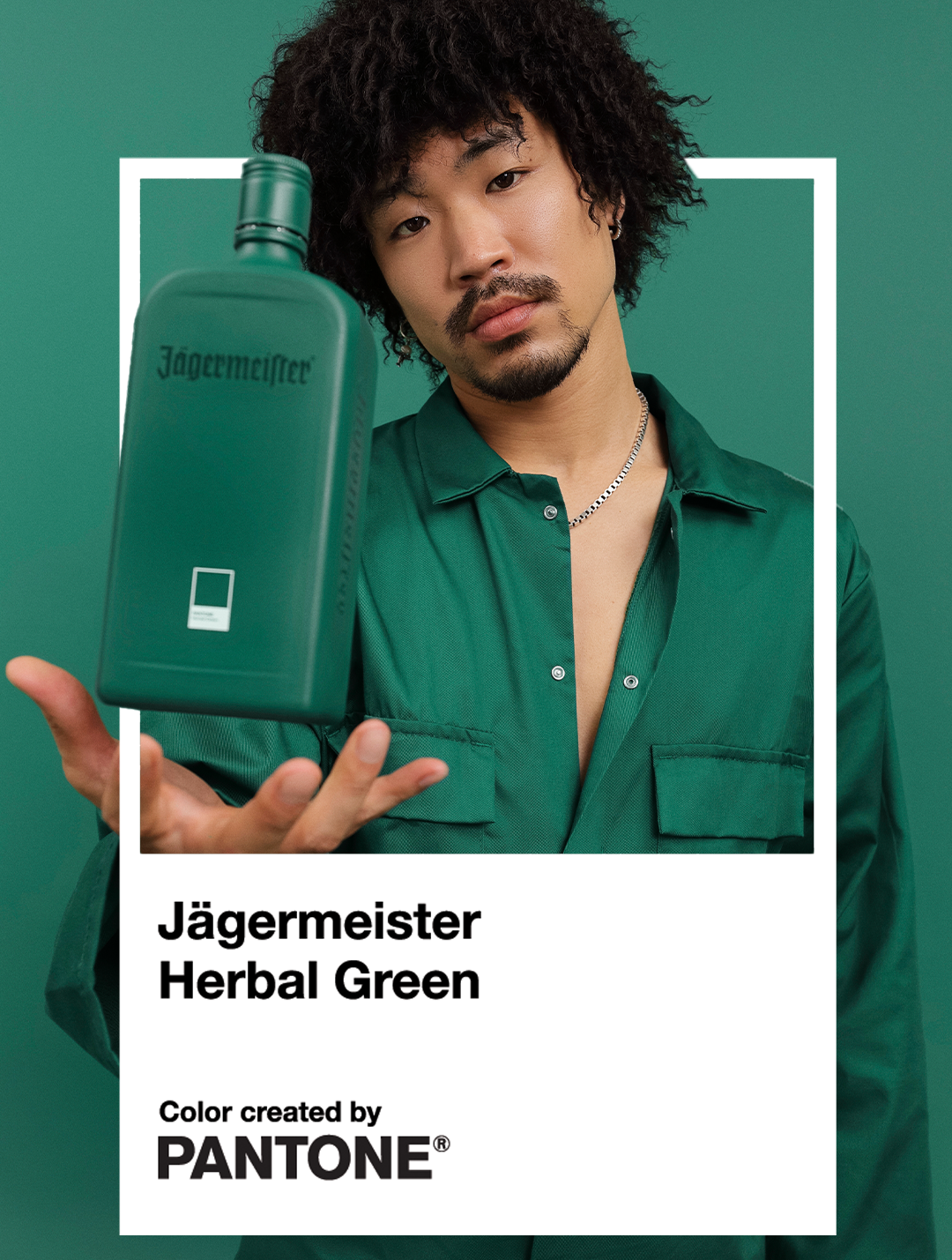 A man in a green shirt holds up a green bottle of Jägermeister Herbal Green, with a white text box below reading 'Jägermeister Herbal Green' and 'Color created by PANTONE'.