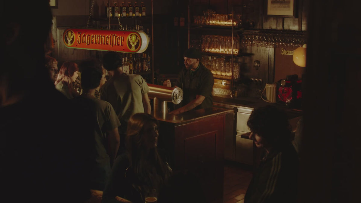 A retro-themed Jägermeister campaign video featuring archival-style footage, vintage-inspired visuals, and classic Jägermeister branding. The video showcases historic advertising moments, product packaging from different eras, and cultural references connected to the brand’s heritage, celebrating Jägermeister’s long-standing presence and evolution over the decades.