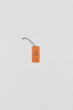 Orange side of fragrance paper with  brand logos on a white background