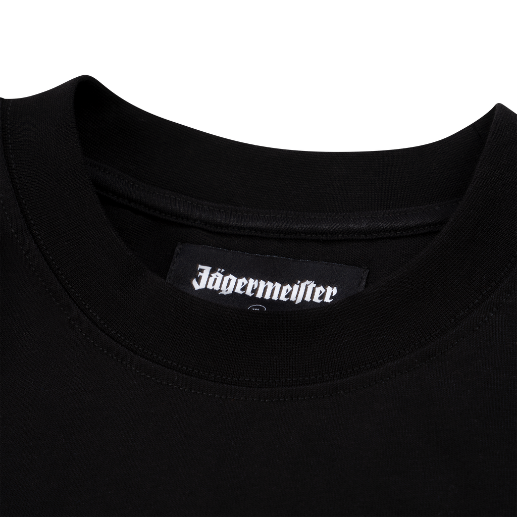 Close-up of a black Jägermeister T-shirt collar featuring a woven Jägermeister logo label inside the neckline.