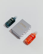 Two bottles of Krink paint markers and a Krink branded box 