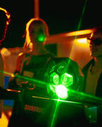 Green shining LIghtboks with placed on a Soundboks surrouended by people partying 
