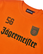 Orange Jägermeister longsleeve with black Jägermeister wordmark and a '56'.