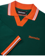 Green Jägermeister polo shirt with orange collar and trim featuring Jägermeister branding.