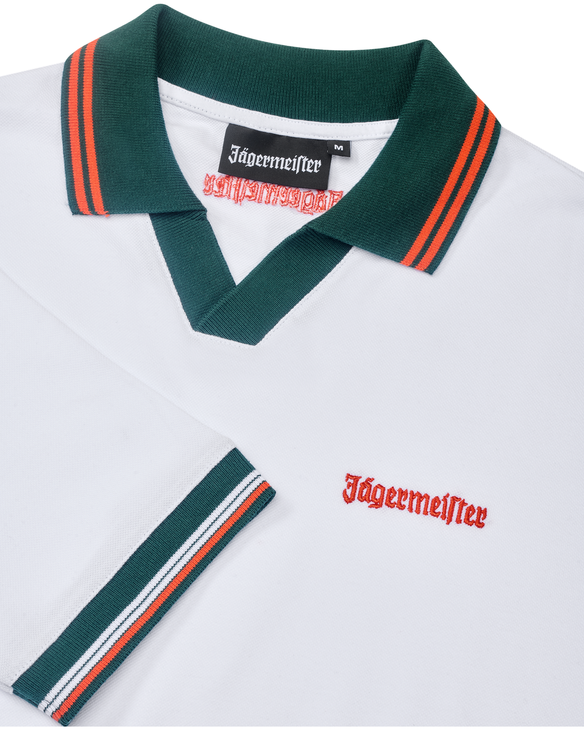 White Jägermeister polo shirt with green collar and orange trim featuring orange Jägermeister branding.