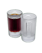 Two white Jägermeister shot glasses with a dark liquid inside