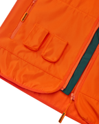 Close-up of an orange Jägermeister vest with two front pockets for Jägermeister Minis.