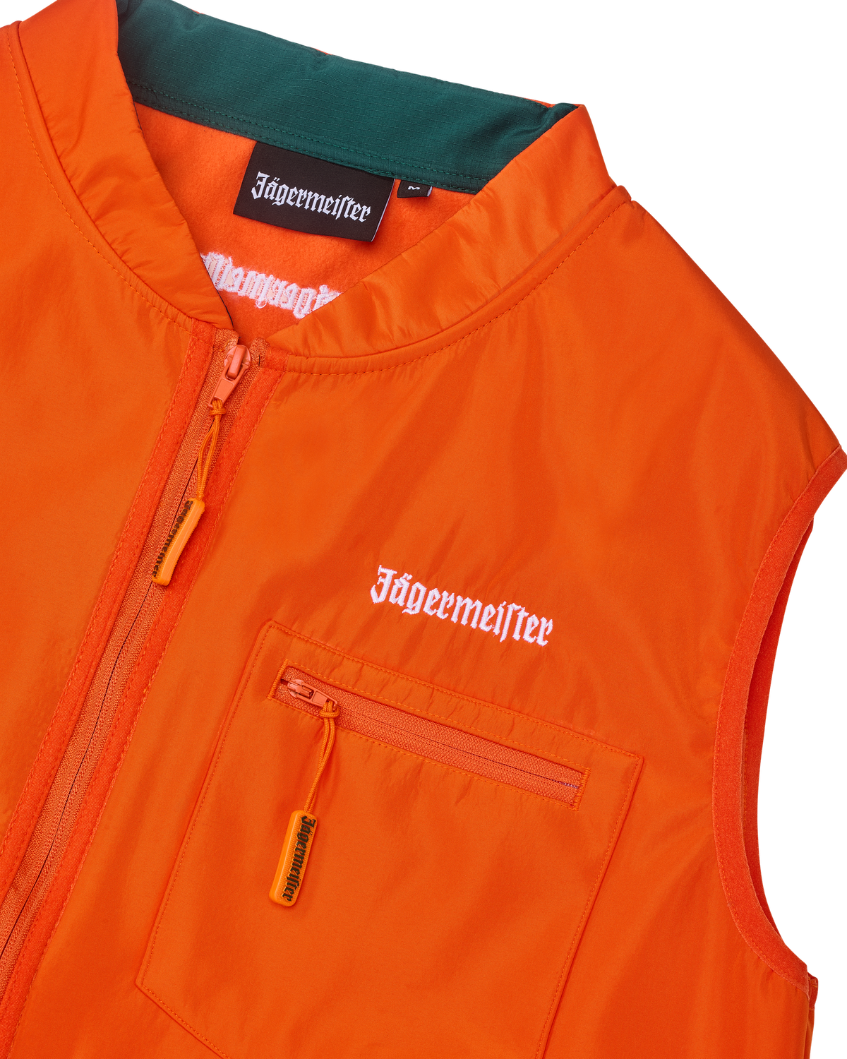 Close-up of an orange vest with white Jägermeister branding.