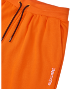 Orange Jägermeister sweatpants with a black drawstring and a white brand logo.